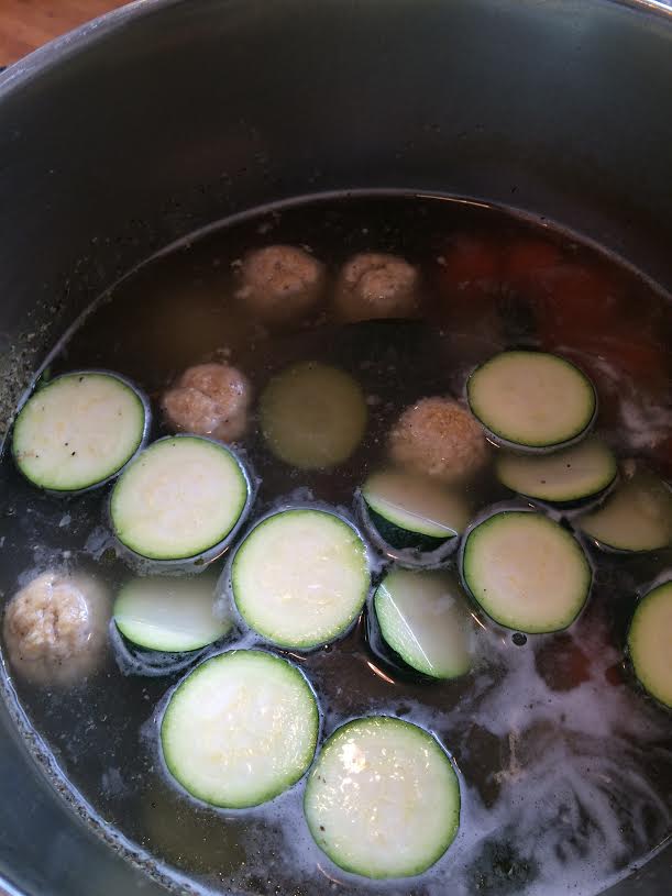 chicken soup cooking in pot