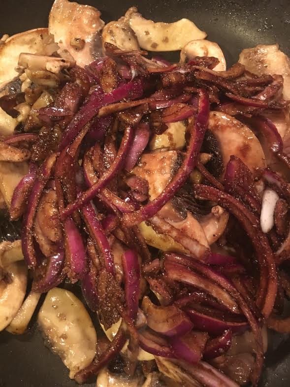 warm mushroom salad-mushrooms and pickled onions in fry pan
