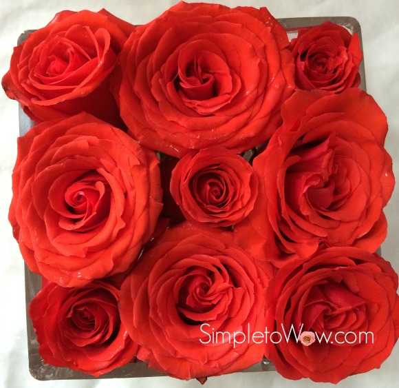 last week's roses in a square bowl