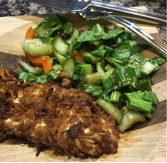 onion crusted chicken with baby bok choy salad on wooden plank